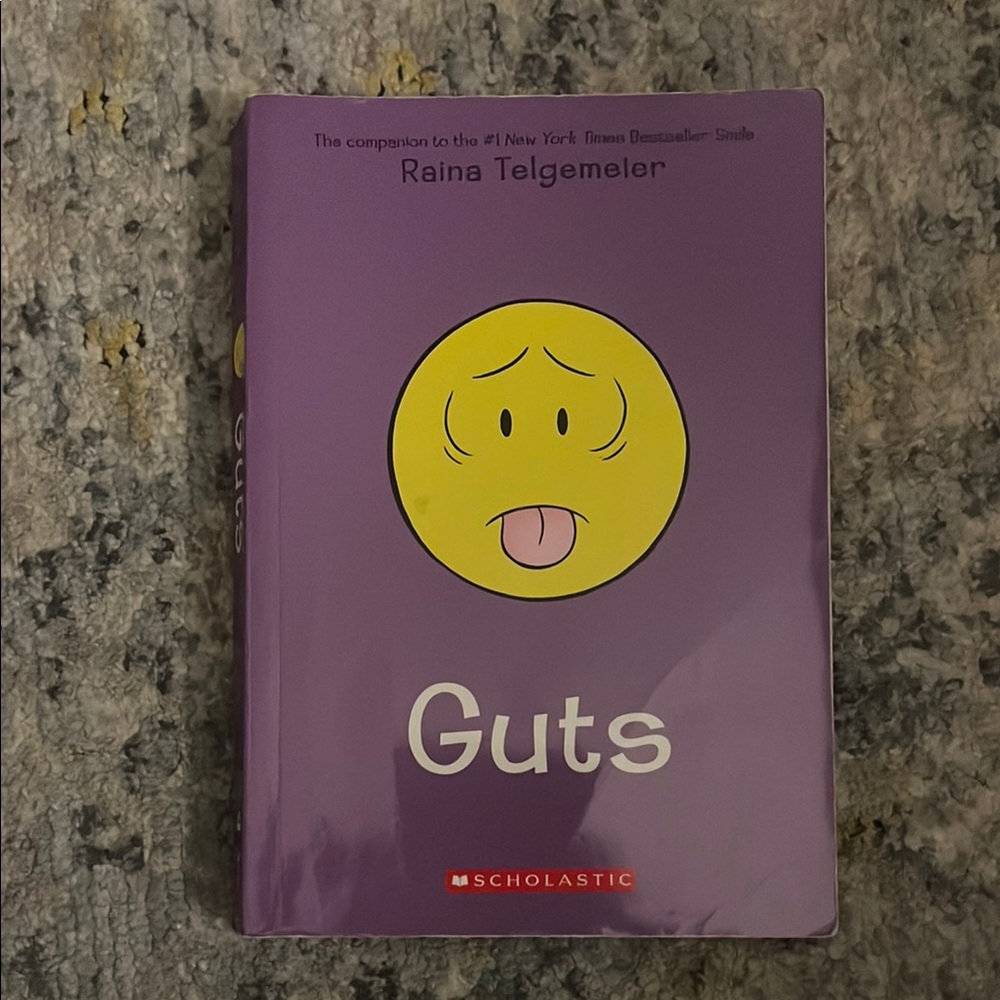 Scholastic Purple Graphic Novel with Yellow Face
